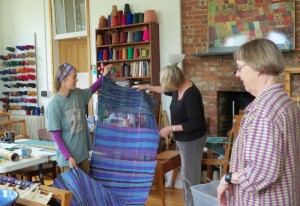 Students examining woven cloth